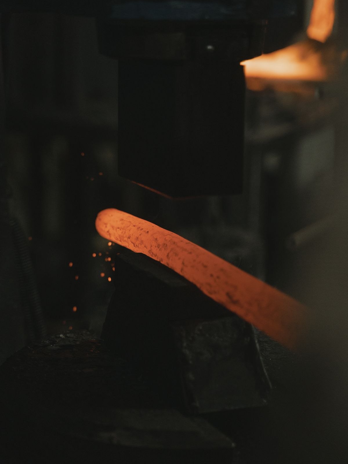 Glowing metal in an industrial forge