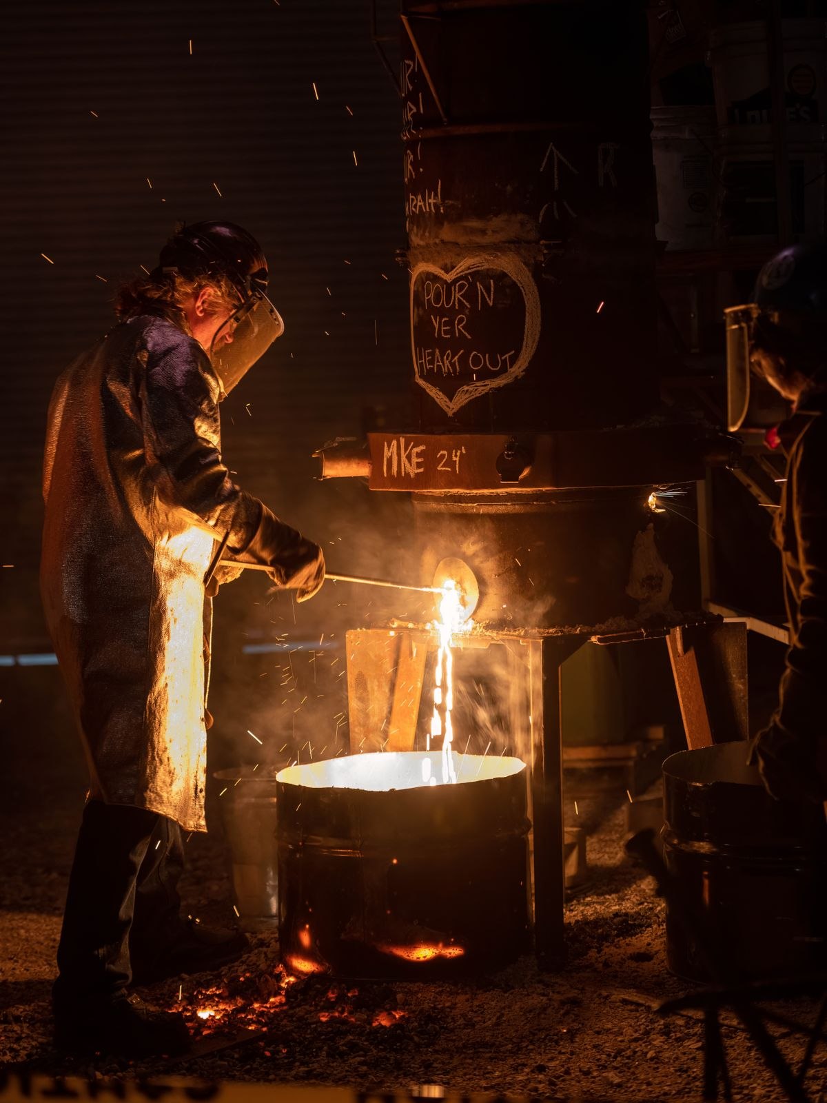 Worker managing a furnace in an industrial plant