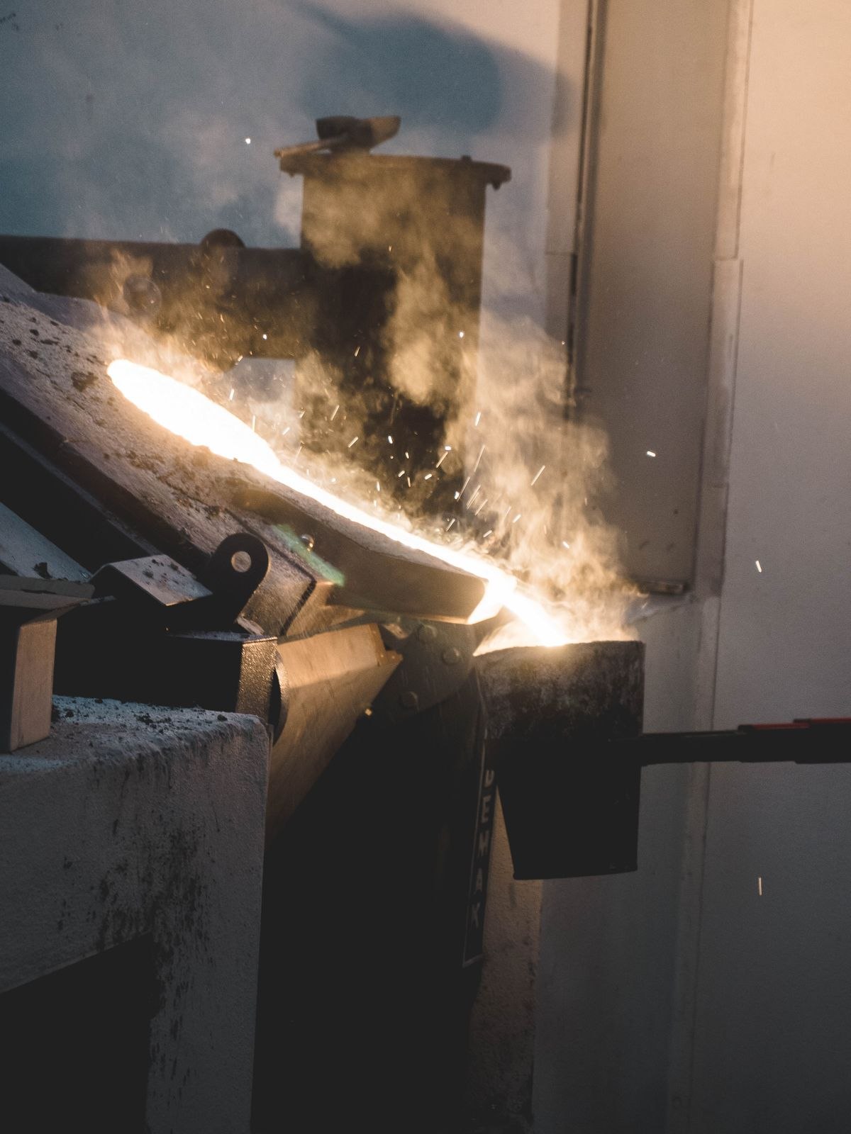 Molten metal being poured in an industrial foundry