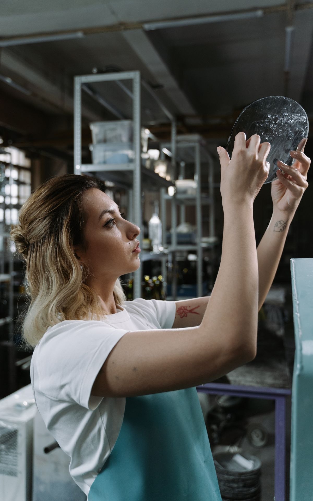 Engineer inspecting a metal component in an industrial workshop